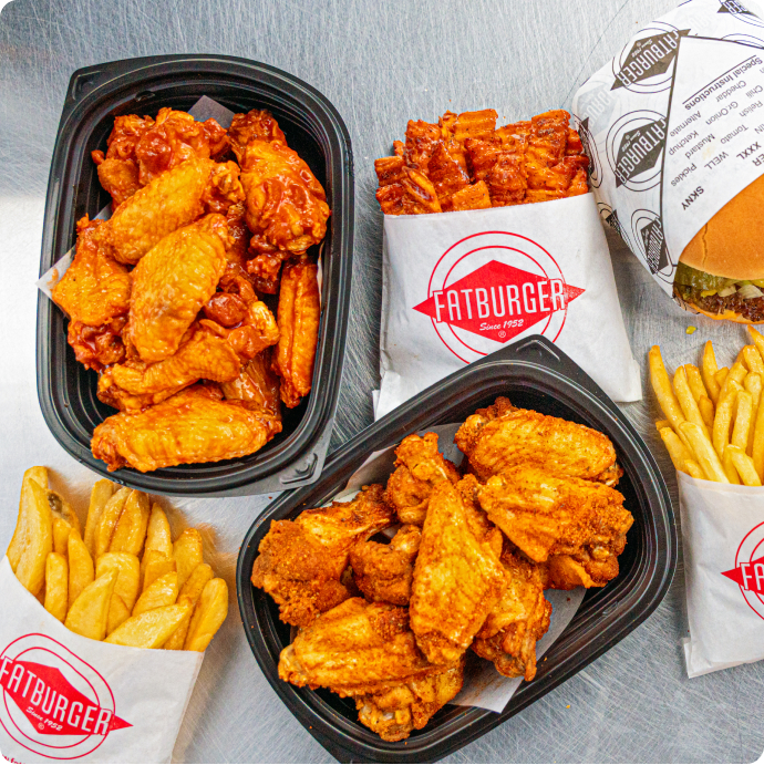 an overhead photo of a fatburger, fries, and wings